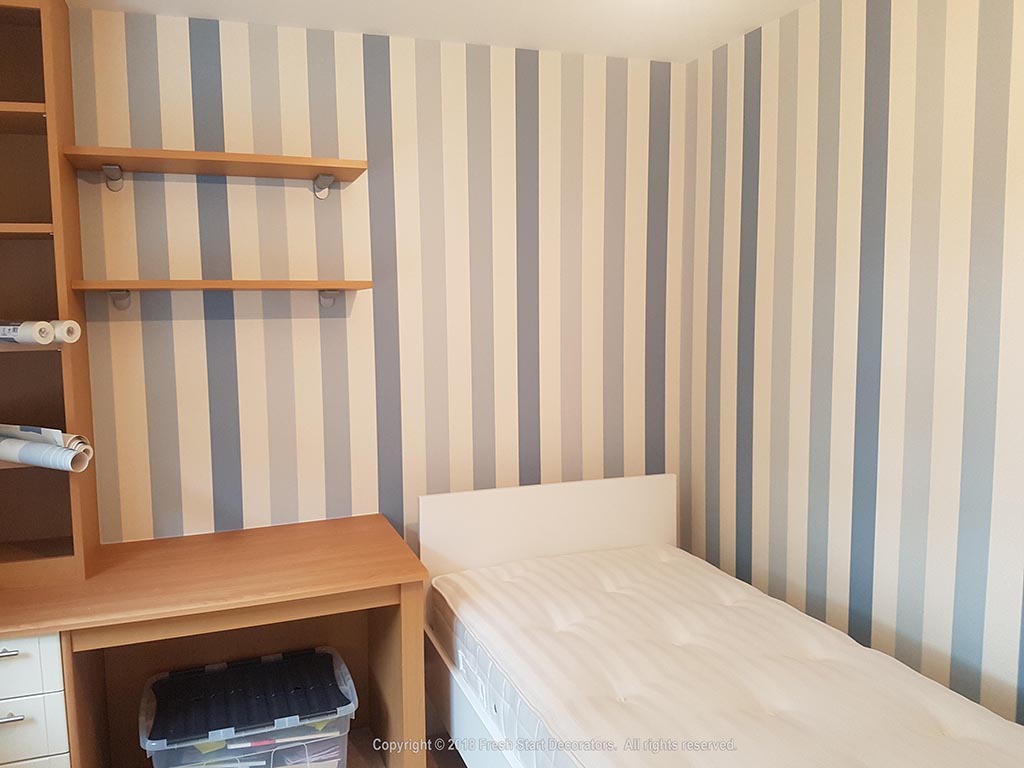striped wallpaper applied to bedroom in birmingham